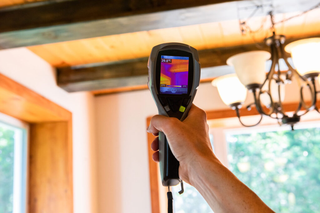 Person using thermal camera to confirm insulation levels while conducting apartment mold testing